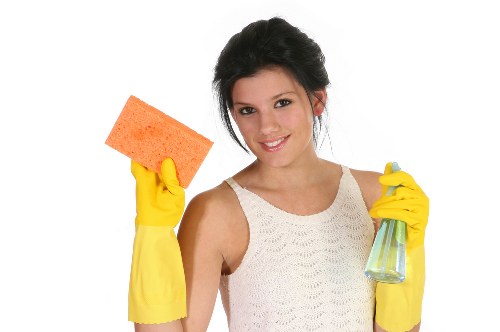 Carpet cleaning technician with safety equipment in a home setting